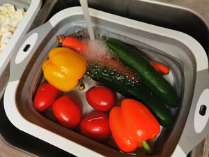 Washing vegetables in plastic tub